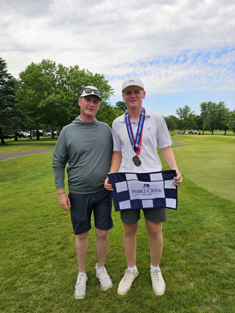 Student receiving golf award