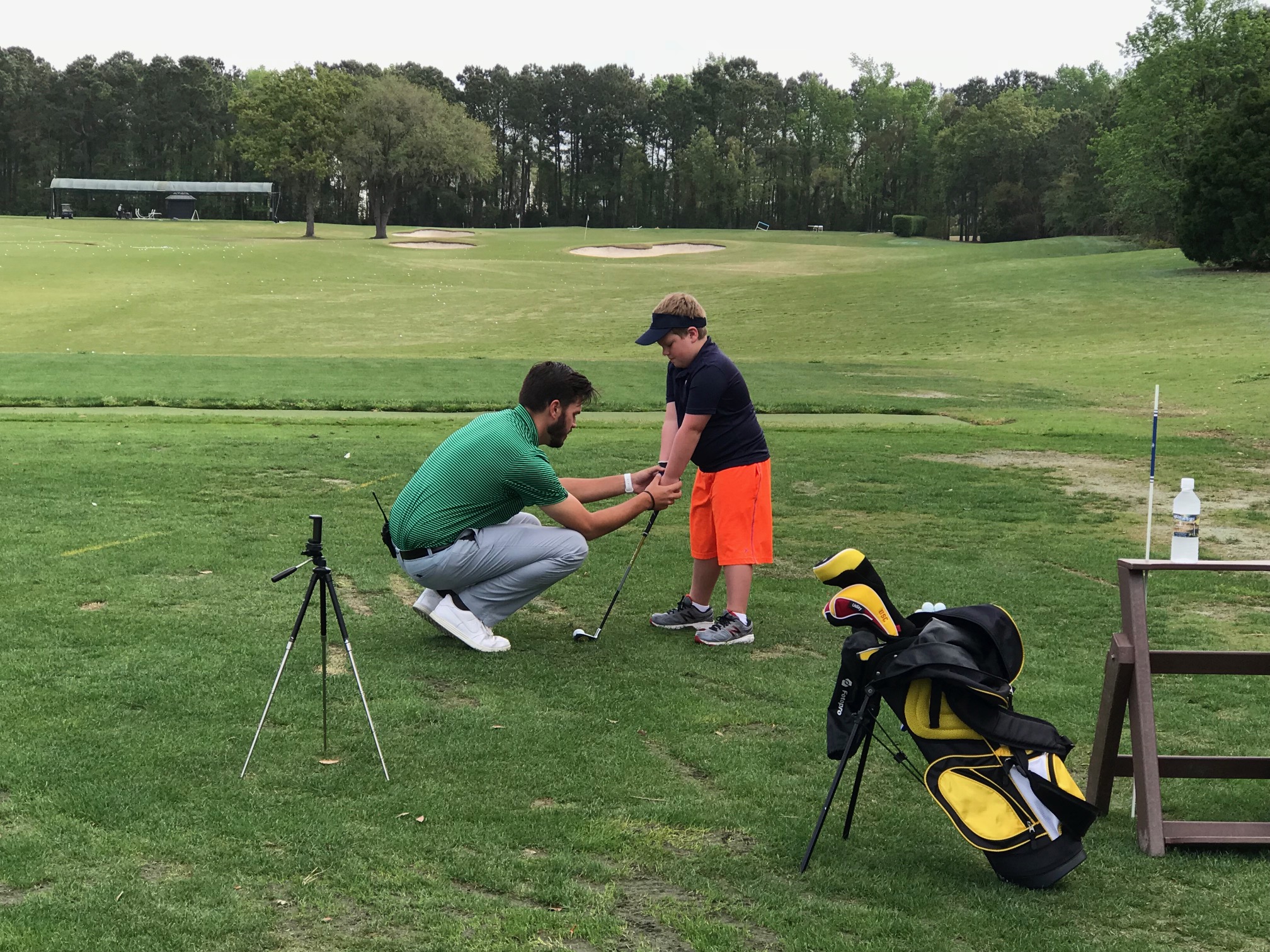 Zach coaching junior golfer one on one
